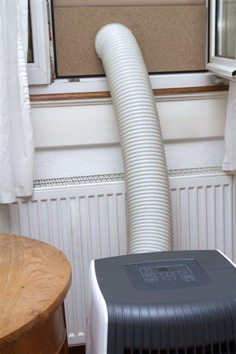 A hose on the back of the unit attaches to a window kit that sits on the window sill to exhaust hot air. How to Use a Portable Air Conditioner Without Hoses | Hunker