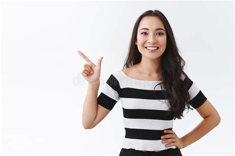 Determined Good Looking Asian Woman In Striped T Shirt Recommend Product Hold Hand On Hip Self