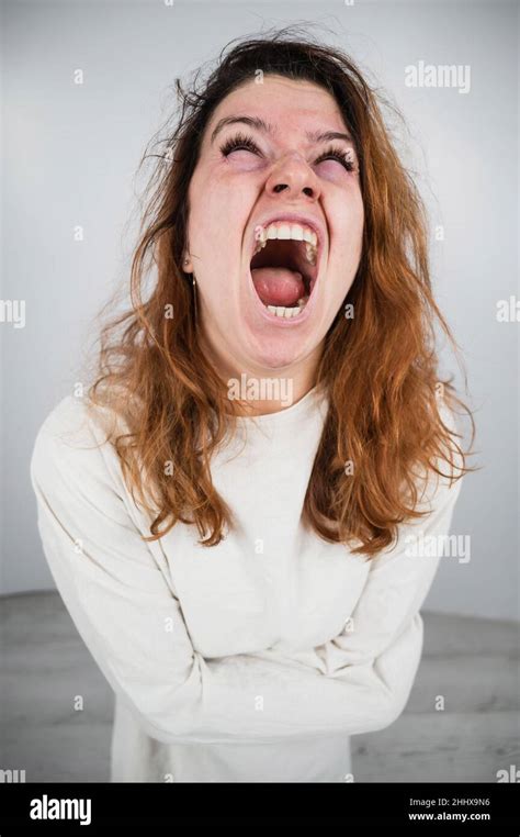 Close Up Portrait Of Insane Woman In Straitjacket On White Background