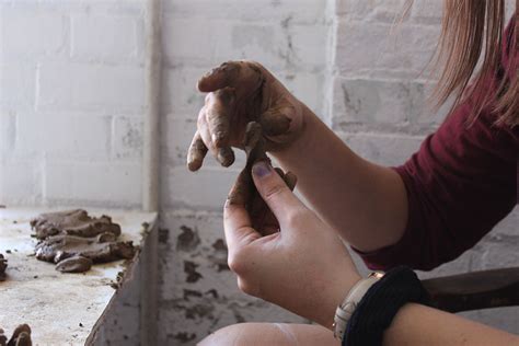 Girl Works Clay With Her Hands