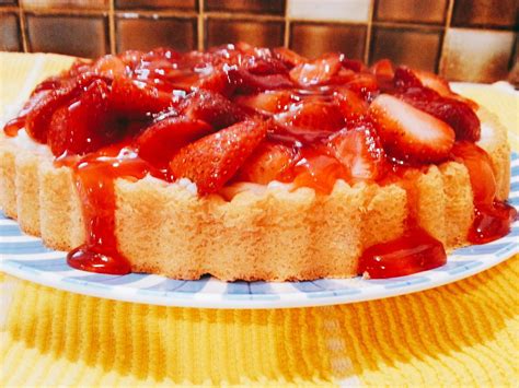 A Delicious Custard Flan Topped With Strawberries And Jelly Torte