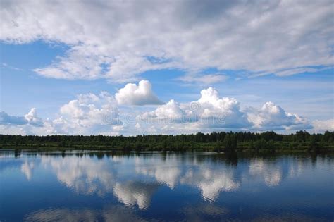 Daytime Landscape With Beautiful Clouds Reflected In River Or Lake