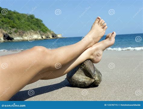 Female Legs Resting On Coconut Tropical Beach Royalty Free Stock Photo