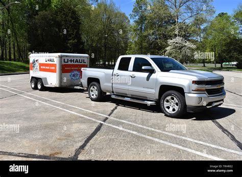 A 2018 Chevrolet Silverado Pickup Truck pulling a U-Haul trailer Stock