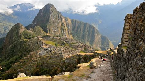 | shrouded by mist and surrounded by lush vegetation and steep escarpments, the sprawling inca citadel of machu picchu. Mountain Wonder Machu Picchu Peru | The World Travel