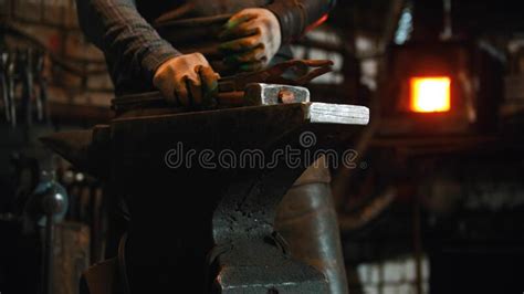 Forging Industry Indoors With Working Blacksmith Hammer On The Anvil