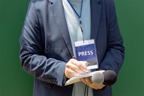 Journalist With Press Pass At News Conference Or Media Event Holding