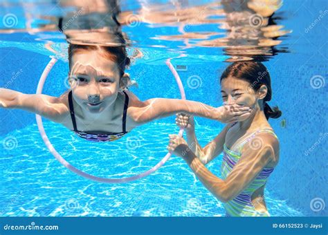 Children Swim In Pool Underwater Happy Active Girls Have Fun Under