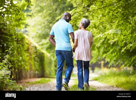 Mature African American Couple Walking In Countryside Stock Photo Alamy