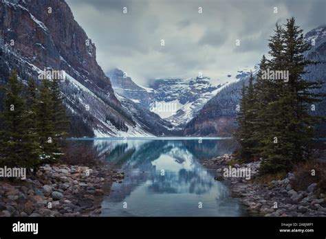 Lake Louise On A Cloudy Day Reflection Of The Snowed Mountains And The