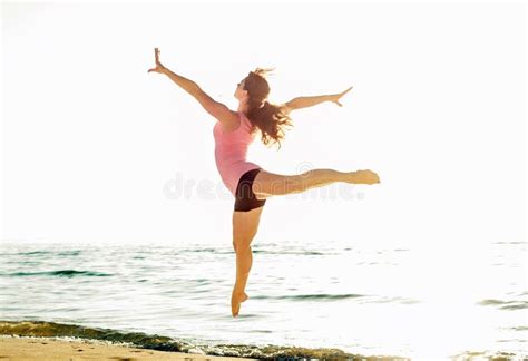 Beautiful Sporty Woman Jumping On Seaside Gymnast Female Doing Stock