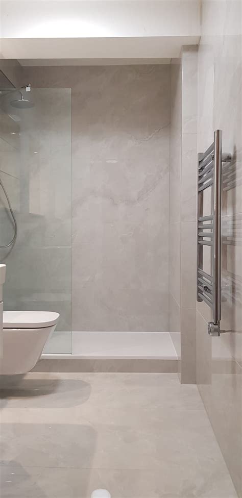 Light Grey Onyx Effect Porcelain Tile In A Bathroom With Walk In Shower