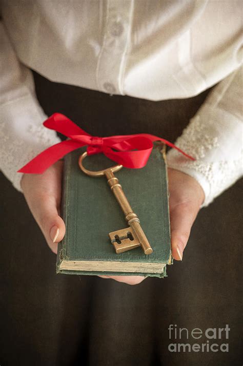Woman Holding A Book With A Key Tied With Red Ribbon Photograph By Lee