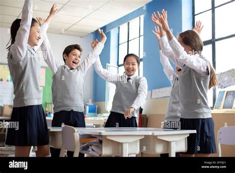 Classmates Cheering In Classroom Stock Photo Alamy