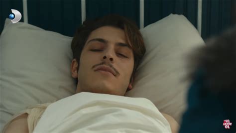 A Man Laying In Bed With His Eyes Closed