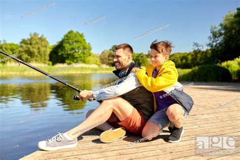 Happy Smiling Father And Son Fishing On River Stock Photo Picture And