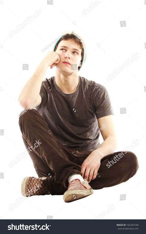 Sit on the floor with legs straight out in front. Young Man Dressed In Hip Style Sitting Cross Legged And ...