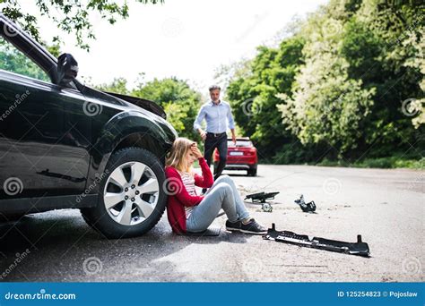 Young Woman By The Car After An Accident And A Man Running Towards Her Stock Image Image Of
