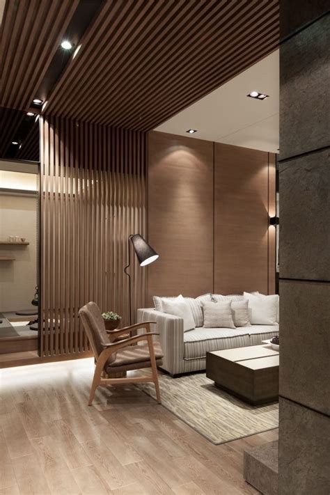 A Modern Living Room With Wood Paneling And White Furniture In The
