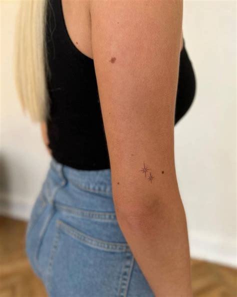 Minimalistic North Stars Tattooed On The Upper Arm