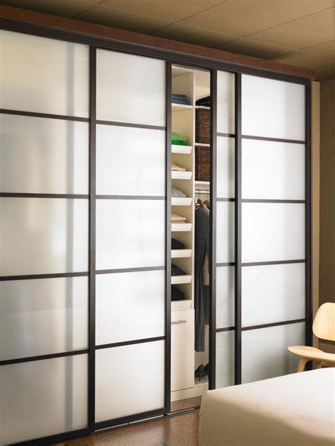 Rectangular glass cutout closet door ideas. large-white-wooden-sliding-doors-with-black-wooden-frame ...