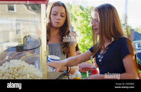 Girls Serve Themselves Popcorn At Neighbourhood Block Party Stock Video