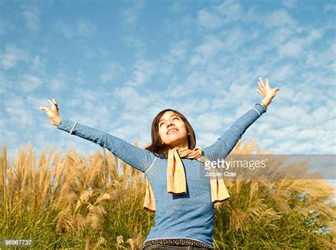 mature beautiful woman reaching up to sky photos and premium high res pictures getty images