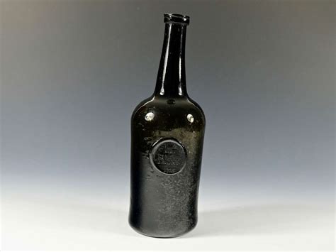 Sealed cylindrical wine bottle dated 1775 in English wine bottles