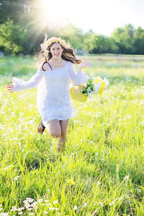 Woman Running Through Green Grass Field Holding A Flower Basket During
