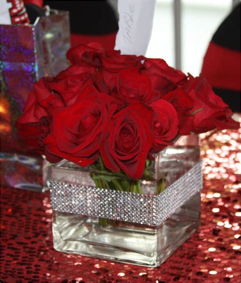 Red Rose Centerpieces In Clear Box Vases For A Christmas Party Table