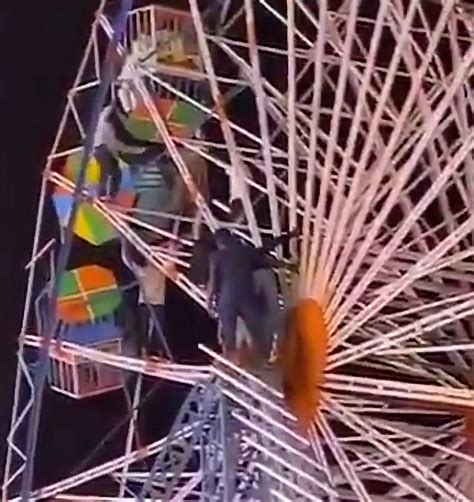 Heart-stopping moment rescuers climb Ferris wheel after carriages flip