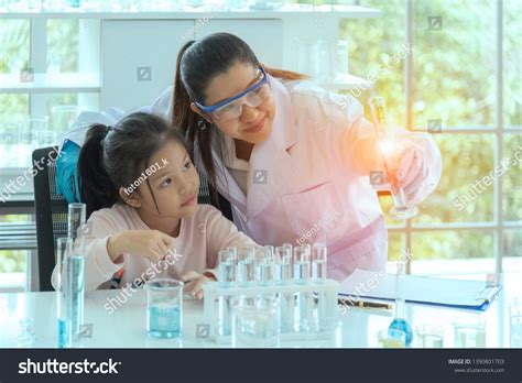 Scientists Explaining Experiment Doctor Teaching Girls Stock Photo