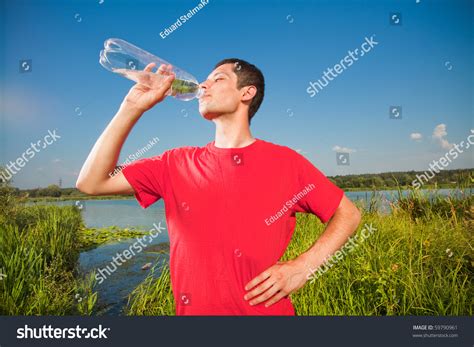 Young People Drink Water From A Bottle Stock Photo