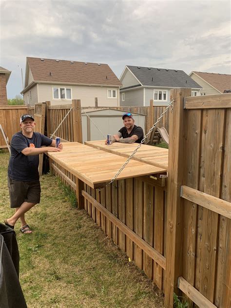 These Neighbors Adjusted Their Fence So They Could Enjoy A Beer