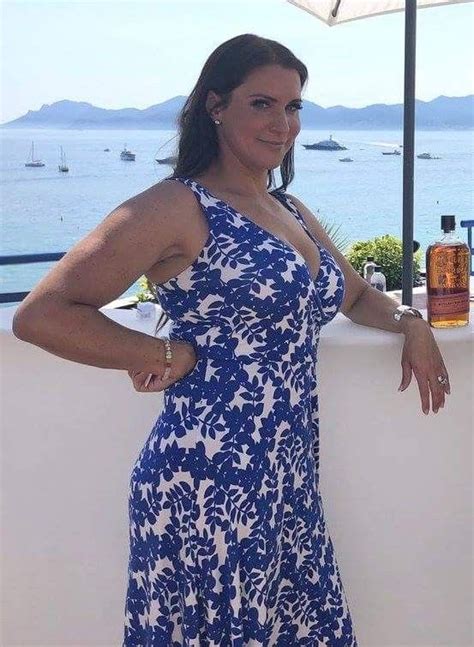 A Woman In A Blue And White Dress Posing For The Camera