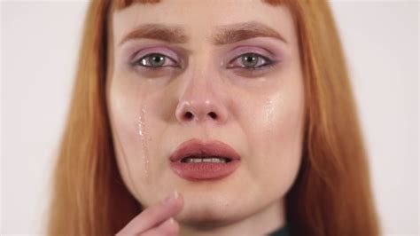 Young Beautiful Crying Female Remove Tears From Her Face And Showing