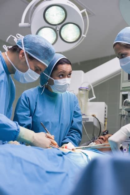 Premium Photo Serious Doctors Operating A Surgical Tools