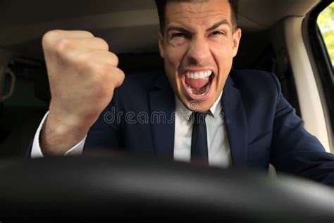 Emotional Man Yelling In Car Aggressive Driving Behavior Stock Photo