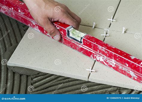 Ceramic Tiles And Tools For Tiler Worker Hand Installing Floor Tiles