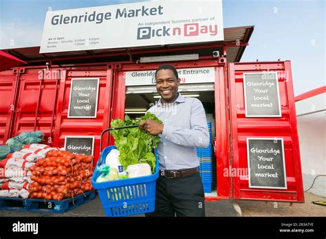 Owner manager standing outside Entrance at local Pick n Pay grocery