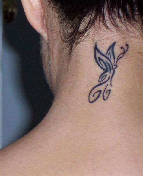 A Womans Neck With A Butterfly Tattoo On The Back Of Her Left Shoulder