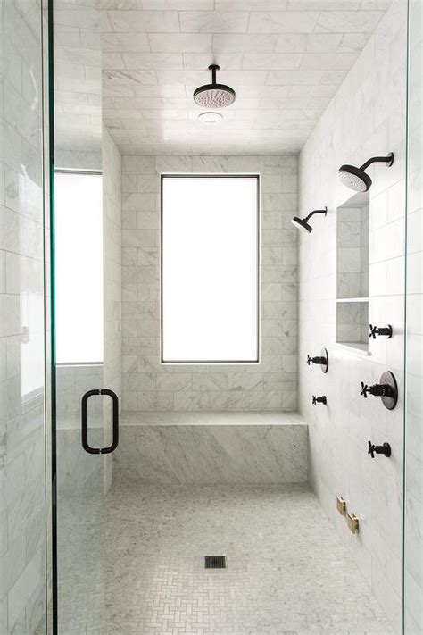 The classical carrera marble look in a modern layout. Gray and Gold Shower Design with Carrera Marble Tiles ...