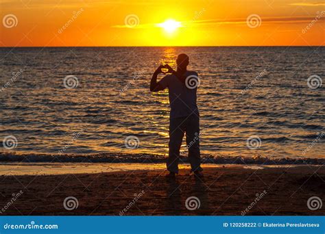 A Man Enjoys Life On The Beach At Sunset Stock Photo Image Of Jumping