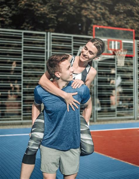 Young Sports Couple Having Fun Hugging On Basketball Court Leisure Actitvities Outdoors Stock