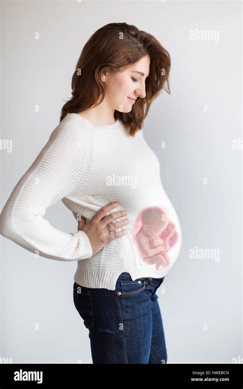 Superimposed Newborn Baby Inside The Mothers Pregnant Belly A Concept