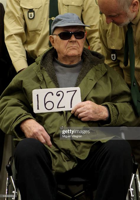 Accused Nazi Criminal John Demjanjuk Holds A Sign Showing The Number