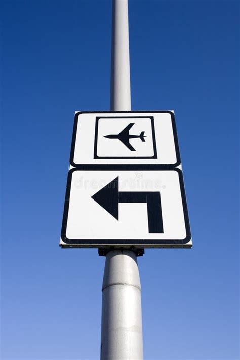 Airport Traffic Sign With Arrow Pointing Left Against Blue Sky Stock