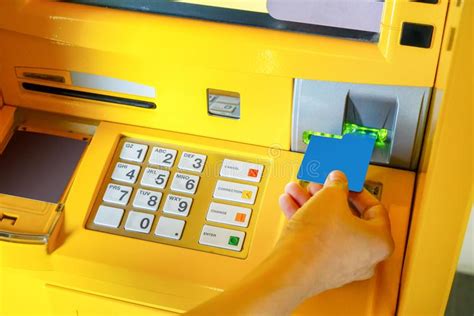 Hand Of Asian Woman Inserting Atm Card Into Atm Machine Stock Image