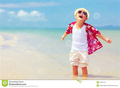 Happy Fashionable Kid Boy Enjoys Life On Summer Beach