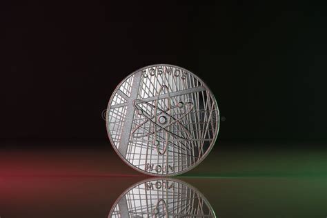 Cosmos Atom Crypto Coin Placed On Reflective Surface And Lit With The Green And Red Lights Stock